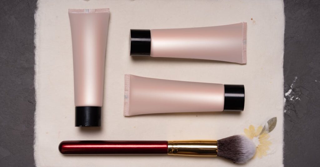 Beauty composition featuring cosmetic tubes and a makeup brush on a textured background.